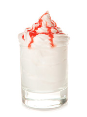 Whipped cream with syrup in glass on white background