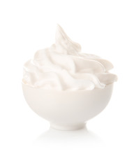 Whipped cream in bowl on white background