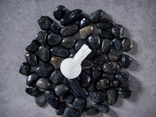 Herbal compress ball placed on black stone.
