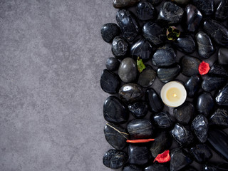 Black river rocks on gray marble background.