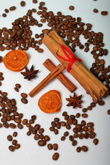 Coffee beans, cinnamon sticks, allspice and anise. Slices of dried oranges. On white background. World Coffee Day.