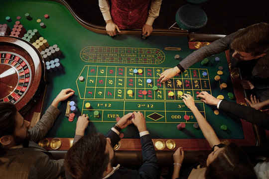 Top View Of People Playing Roulette At The Table In A Casino