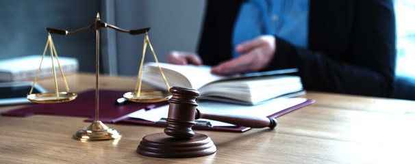 lawyer judge reading documents at desk in courtroom