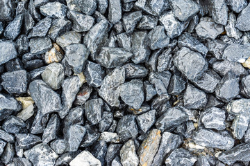 Small rocks or gravel made from  stones different shape as stone texture. Used for construction of buildings and roads and as a building material.