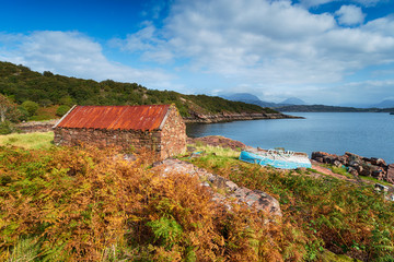 An old croft and a boat on the shores of Loch Torridon