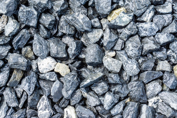 Small rocks or gravel made from  stones different shape as stone texture. Used for construction of buildings and roads and as a building material.