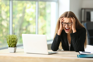 Stressed young woman at workplace