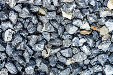 Small rocks or gravel made from  stones different shape as stone texture. Used for construction of buildings and roads and as a building material.
