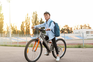 Fototapeta premium Cute boy riding bicycle outdoors
