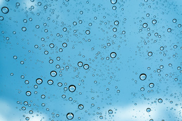 Rain on the window, natural skin of the rain The natural form of rainwater on a sky background.