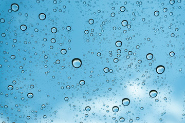 Rain on the window, natural skin of the rain The natural form of rainwater on a sky background.