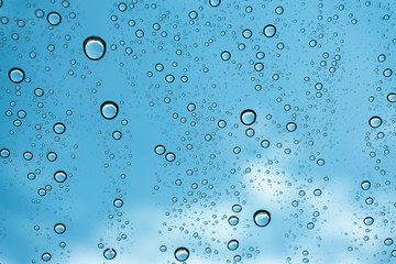 Rain on the window, natural skin of the rain The natural form of rainwater on a sky background.