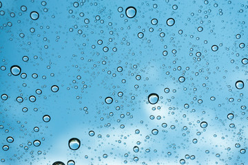 Rain on the window, natural skin of the rain The natural form of rainwater on a sky background.