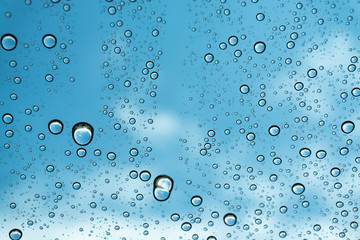 Rain on the window, natural skin of the rain The natural form of rainwater on a sky background.