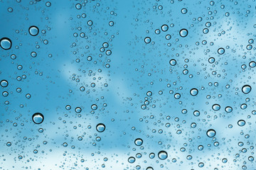 Rain on the window, natural skin of the rain The natural form of rainwater on a sky background.