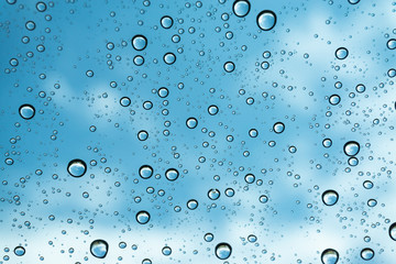 Rain on the window, natural skin of the rain The natural form of rainwater on a sky background.