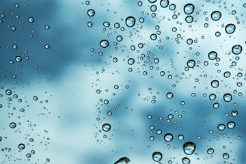 Rain on the window, natural skin of the rain The natural form of rainwater on a sky background.