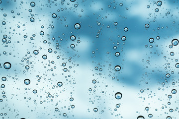 Rain on the window, natural skin of the rain The natural form of rainwater on a sky background.