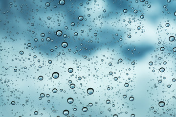Rain on the window, natural skin of the rain The natural form of rainwater on a sky background.
