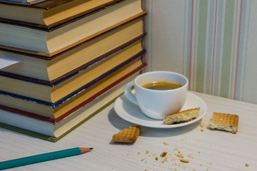 Espresso Cup with cookies and books on the white table