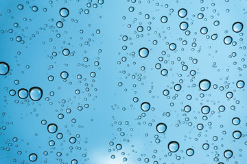 Rain on the window, natural skin of the rain The natural form of rainwater on a sky background.