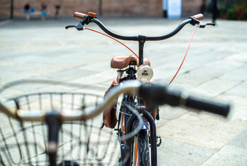 Black bike mounted on a bicycle stand on italian street.