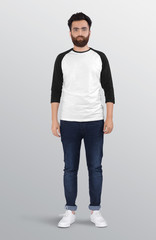 Bearded male model wearing white and grey 3/4 sleeve raglan shirt in dark blue denim jeans pant. isolated background