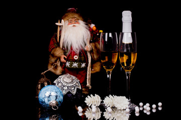 Two glasses with champagne, Santa Claus and Christmas decoration