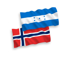 National vector fabric wave flags of Norway and Honduras isolated on white background. 1 to 2 proportion.