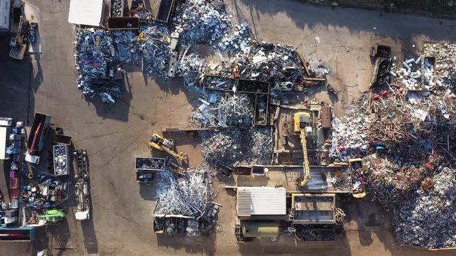 Recycling landfill scrap yard with excavators sunny day aerial top shot  Montpellier France