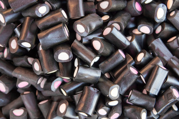 Wallpaper of black English licorice. Top view. Close up