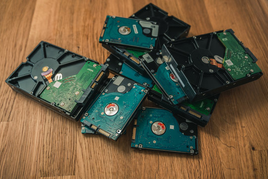 Pile of used harddrives on wooden table