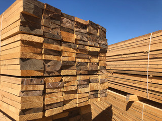 Stack of lumber at the outdoor warehouse. Stockpiled edged boards