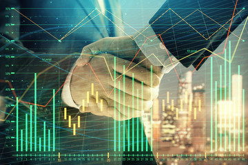 Double exposure of financial chart on cityscape background with two businessmen handshake. Concept of financial analysis and investment opportunities