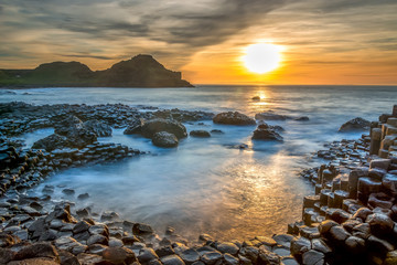Fototapeta premium Giants Causeway Northern Ireland beautiful morning view sunlight long exposure Antrim Coast sunset
