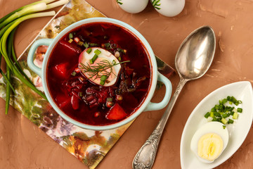 Beet soup in the plate is located on the table, concept is healthy eating, horizontal orientation, top view