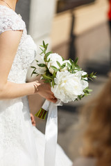 bride with wedding bouquet white peony flowers. peony wedding