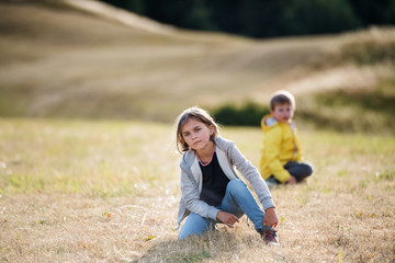 Fototapeta premium School children on field trip in nature, looking at camera.