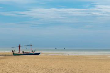Fototapeta na wymiar Small fishing boats park on the beach