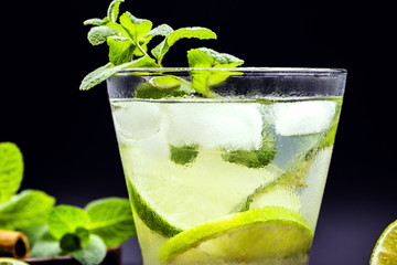 Mojito cocktail on dark wood table. The mojito, a caipirinha-like rum drink with mint leaves.