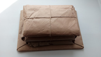 Stacked parcels wrapped in coarse paper.