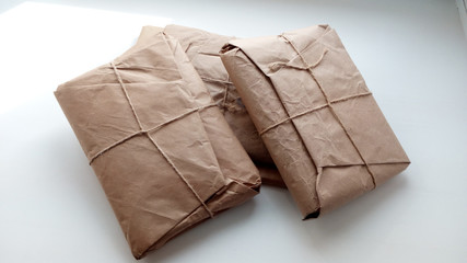 Stacked parcels wrapped in coarse paper.