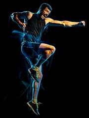 Obraz premium one caucasian player man exercising fitness cardio boxing exercise body combat studio shot isolated on black background with light painting blur effect