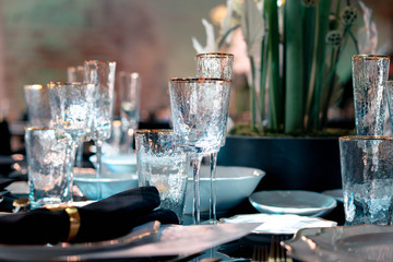 Luxury catering. Wedding or anniversary. Banquet. table served with flowers and glasses for wine or champagne.