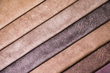 Colorful and bright fabric samples of furniture and clothing upholstery. Close-up of a palette of...