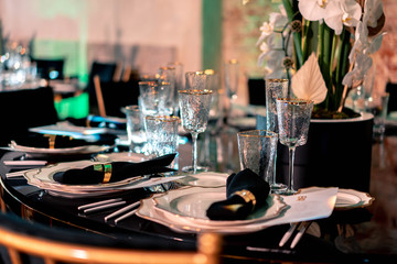Luxury catering. Wedding or anniversary. Banquet. table served with cutlery, flowers, crockery.