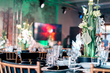 Luxury catering. Wedding or anniversary. Banquet. table served with cutlery, flowers, crockery.