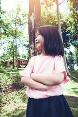 Portrait of a smiling little asian girl in the park.