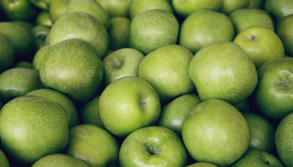 Fresh green apples close up at the market. Healthy food background concept