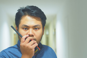 Man with a Walkie Talkie or Portable radio transceiver for Emergency Response Plan